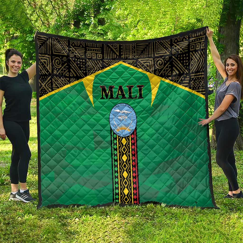 Mali green quilt spread on grass, black border, yellow star panel, Mali crest