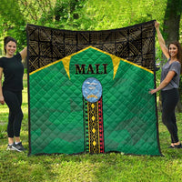 Mali green quilt spread on grass, black border, yellow star panel, Mali crest