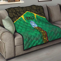 Mali green quilt on sofa, black geometric border, yellow star and Mali crest
