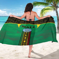 Green Mali sarong with emblem and black geometric stripe border, worn wrap skirt