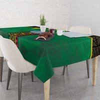 Green Mali tablecloth on dining table with place settings and geometric panel