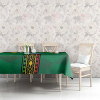 Green Mali tablecloth over bench-style seating with central geometric stripe panel