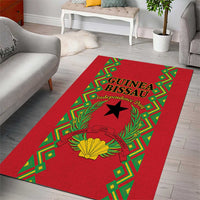Red area rug with green patterned trim, Guinea-Bissau independence text, and star