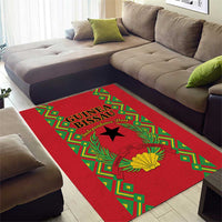 Red area rug with green frame, black star, and yellow laurel flower centerpiece