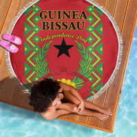Round red beach blanket with fringed edge, Guinea-Bissau independence design, top view