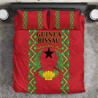 Red bedding set with green geometric border and Guinea-Bissau Independence Day emblem