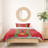 Red duvet and pillow featuring green geometric frame, black star, and laurel wreath