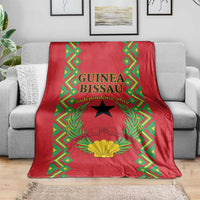Red blanket with Guinea-Bissau Independence Day graphic, black star, gold shell centerpiece