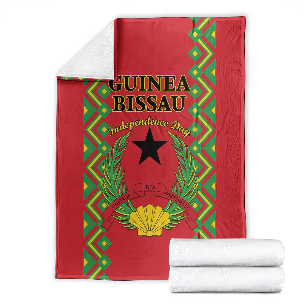 Red folded blanket with Guinea-Bissau Independence Day artwork, black star and golden shell