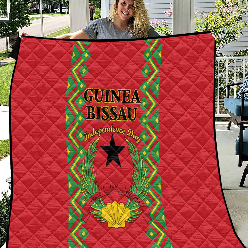 Red quilted throw blanket with Guinea-Bissau emblem panel and green decorative border