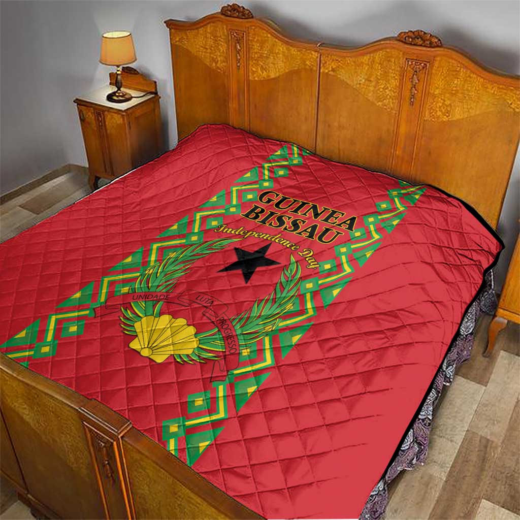 Red quilted bedding throw on bed with Guinea-Bissau crest and green vine border