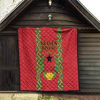 Red quilted wall-hanging blanket with Guinea-Bissau crest and green geometric trim