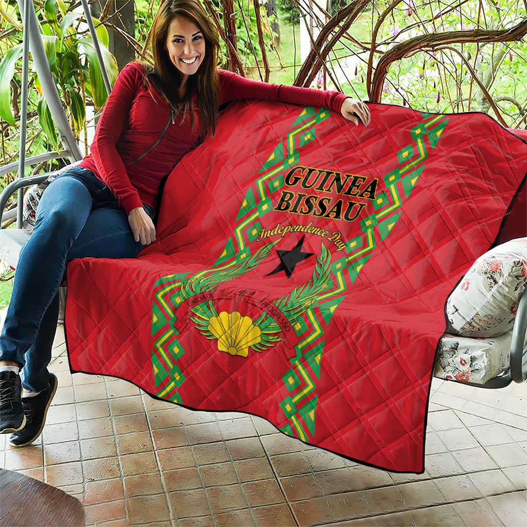 Red quilted throw blanket with Guinea-Bissau crest, black star, and green border