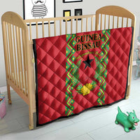 Red quilted blanket for crib with Guinea-Bissau crest panel and green decorative frame