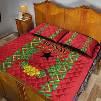 Red quilt bed set with green patterned center, black star, and yellow flower on quilt