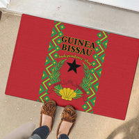 Red rubber doormat showing Guinea-Bissau Independence Day logo with wreath and star