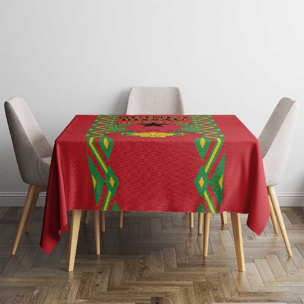 Red tablecloth with green diamond trim and patterned center panel on dining table
