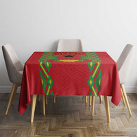 Red tablecloth with green diamond trim and patterned center panel on dining table