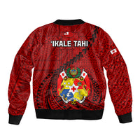 Red bomber jacket with back crest and 'IKALE TAHI' text, black ribbed hem.