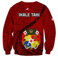 Red sweatshirt back with 'IKALE TAHI' text and crest in geometric Ngatu pattern
