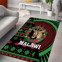 Malawi Christmas area rug with deer face and circular red motif on green-black