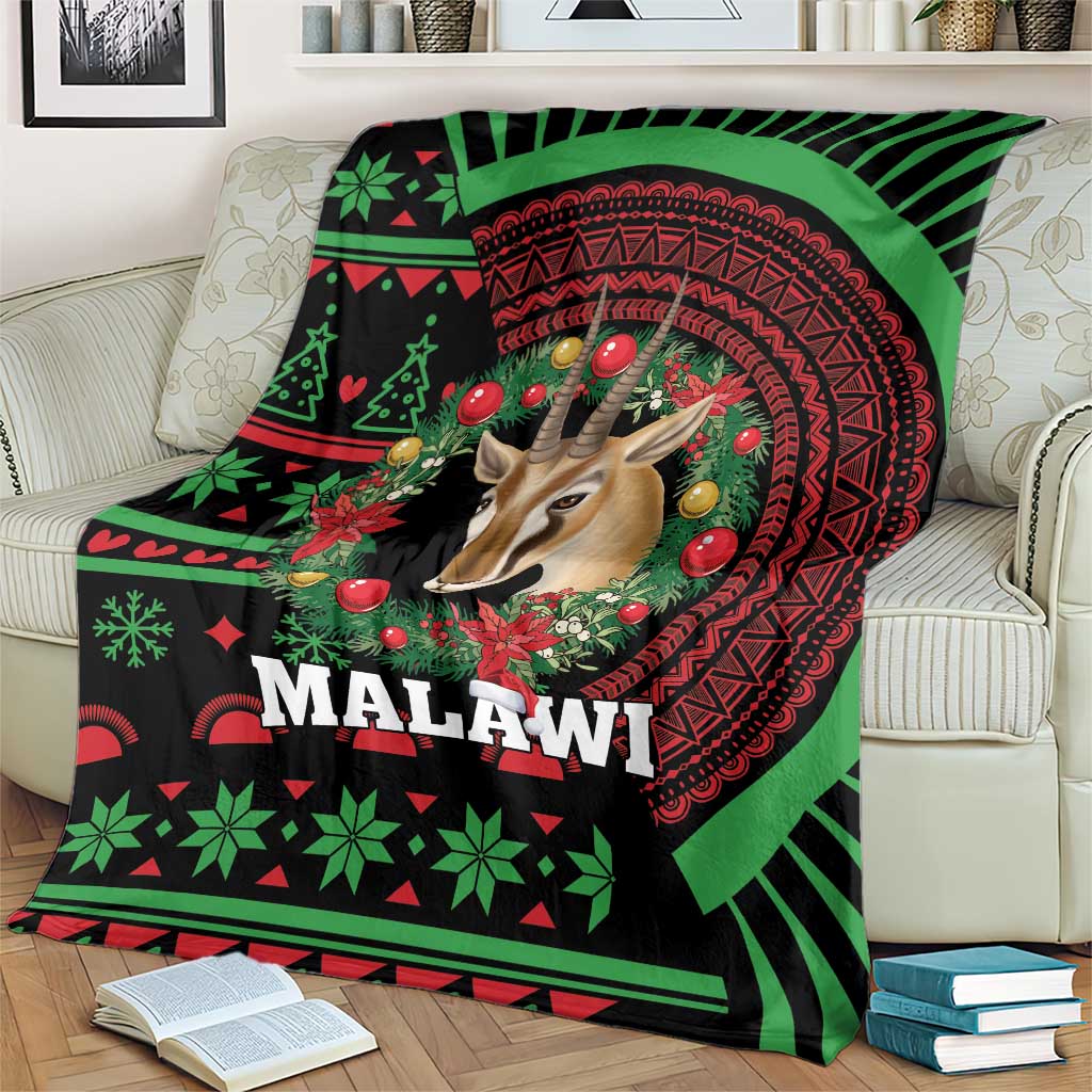 Black Christmas throw blanket with green and red Malawi pattern, gazelle and festive wreath
