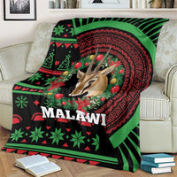 Black Christmas throw blanket with green and red Malawi pattern, gazelle and festive wreath