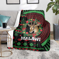 Black Christmas blanket draped on sofa, Malawi holiday design with gazelle and wreath