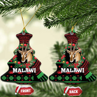 Bell-shaped ceramic ornament with gazelle head, holiday pattern in red, green, and black
