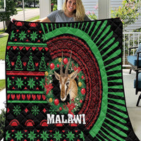 Black Malawi Christmas quilt with green red pattern and giraffe portrait centered