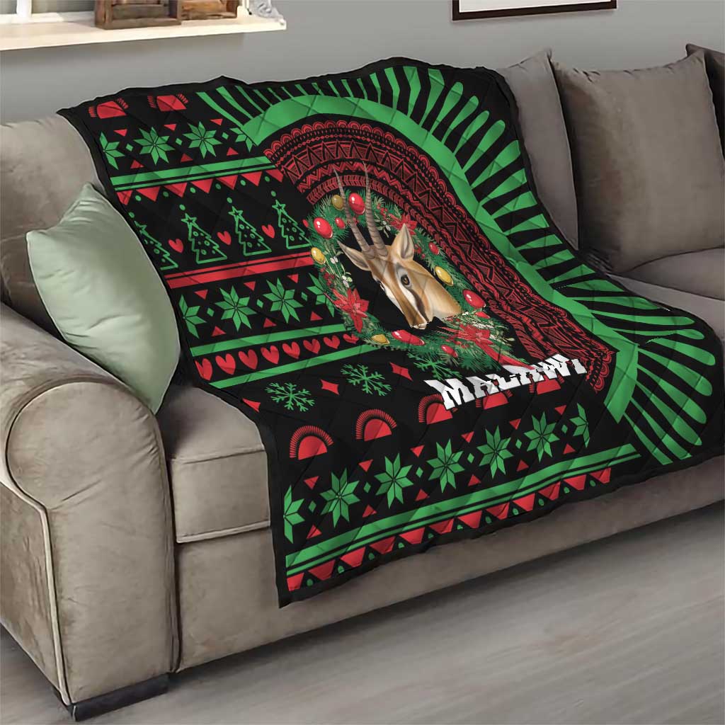 Black Malawi Christmas quilt draped on couch, giraffe portrait and red circular frame