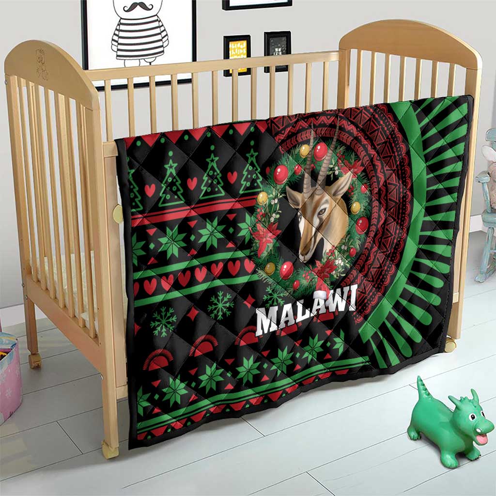 Black Malawi Christmas quilt on crib, giraffe head in red mandala with green holiday icons