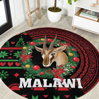 Round rug close-up, black/red/green Malawi text with gazelle and patterned border