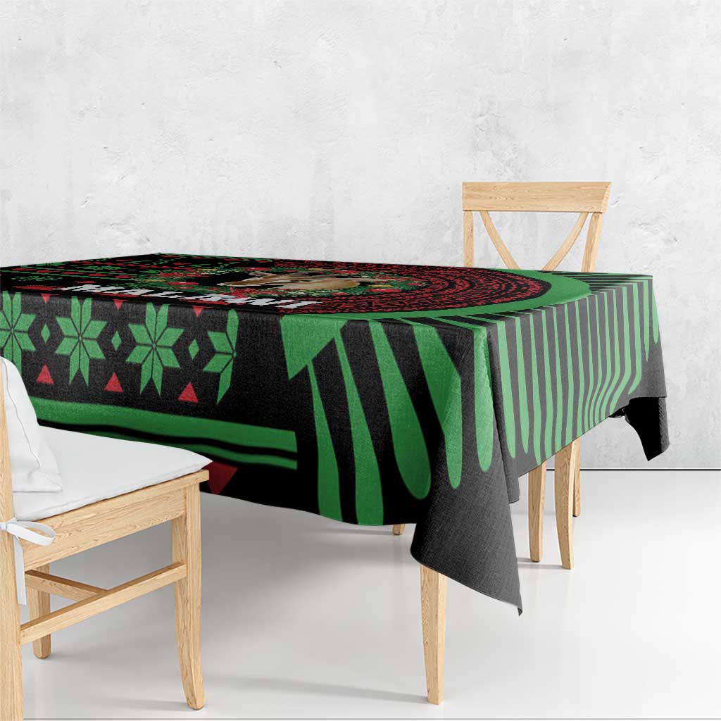 Christmas tablecloth close-up, black and green geometric pattern with bold stripe border