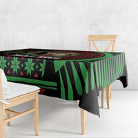 Christmas tablecloth close-up, black and green geometric pattern with bold stripe border