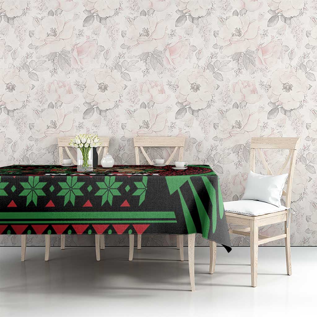 Christmas tablecloth with black, green and red African-style pattern on dining table