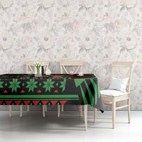 Christmas tablecloth with black, green and red African-style pattern on dining table