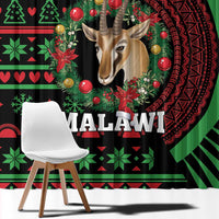 Black curtain close-up with green/red African festive pattern, deer portrait and ornaments