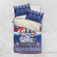 Blue bedding set flat lay with matryoshka Santa doll design, duvet and pillowcases