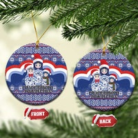 Blue ceramic round Christmas ornament with Santa-style matryoshka figures, gold hanging loop