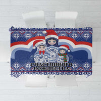 Blue Christmas tablecloth with Santa and matryoshka doll design, decorative border.