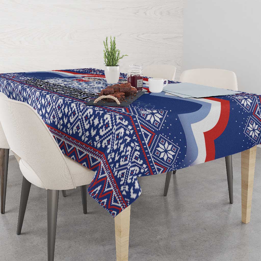 Blue Christmas tablecloth with red and white curved motif and geometric patterns.