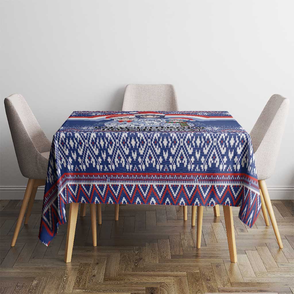 Blue Christmas tablecloth with geometric knit-style stripes and border, square table.