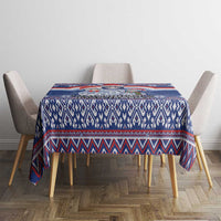 Blue Christmas tablecloth with geometric knit-style stripes and border, square table.