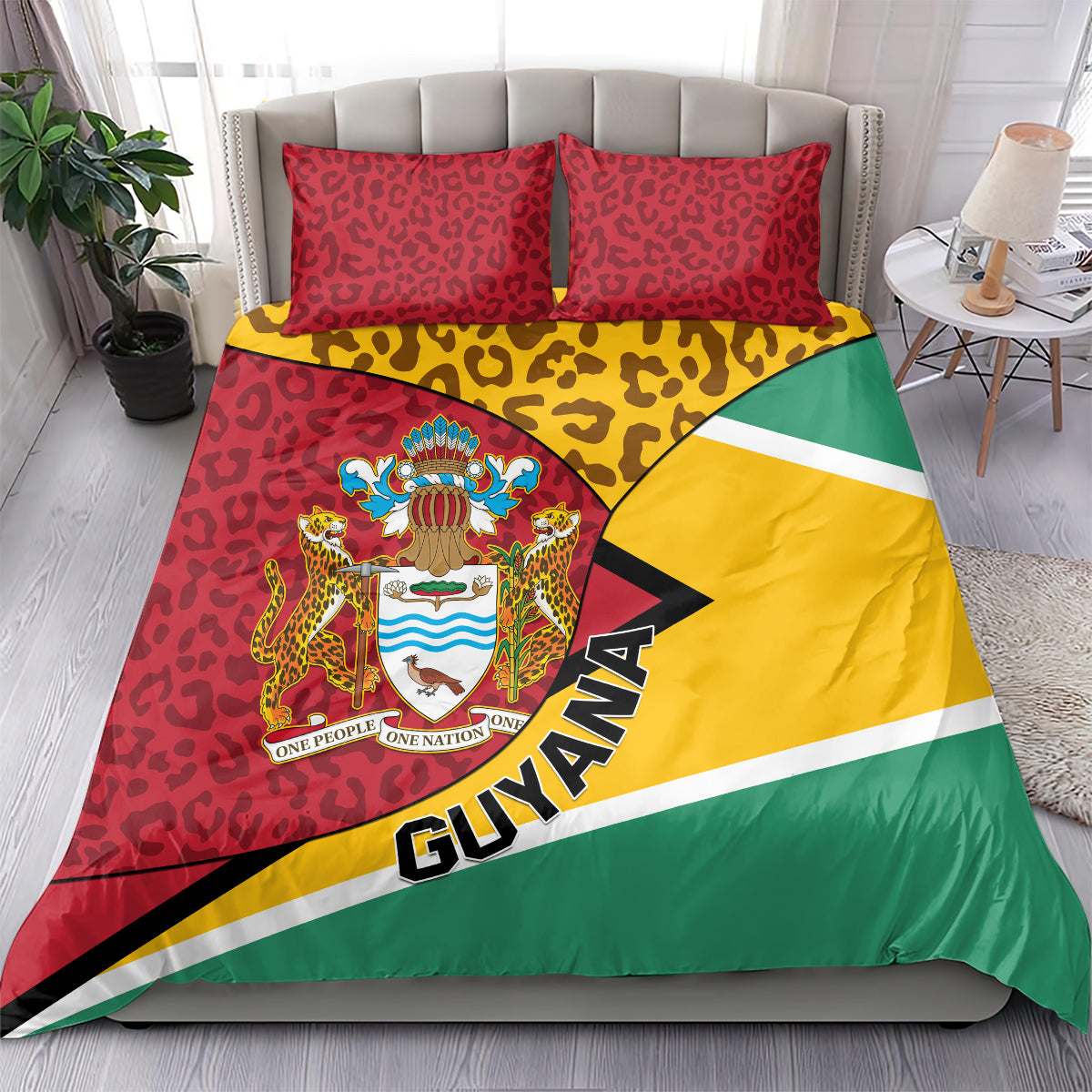 Guyana bedding set on bed with two red leopard pillows and crest, yellow green flag panel