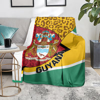 Guyana Republic Day blanket-style coat of arms throw on floor, leopard yellow and green stripes