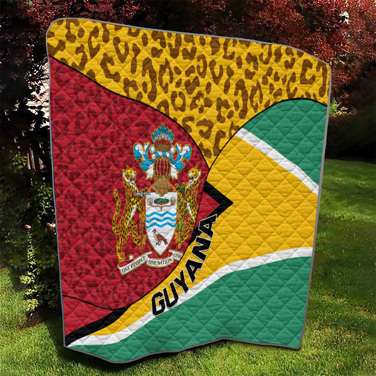 Guyana quilt blanket featuring leopard pattern, crest logo, and green-yellow-red tricolor