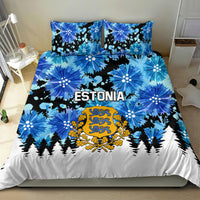 Blue Estonia duvet and pillowcases with floral bursts, gold crest, and fir tree border