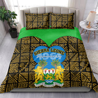 Bedding set draped over bed with green base and black-gold geometric pattern, Sierra Leone Independence Day logo