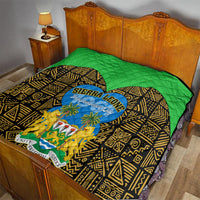 Green and black quilt blanket with yellow geometric motifs and blue Sierra Leone Independence Day logo
